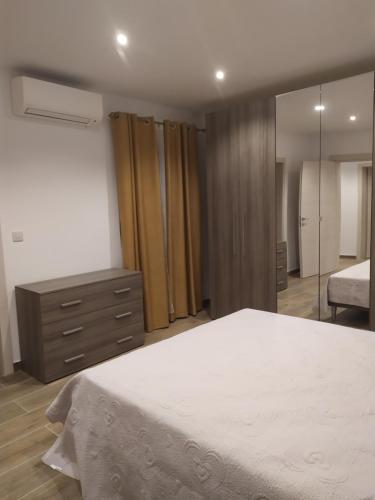 a bedroom with a bed and a dresser and a mirror at Sliema Living in Sliema