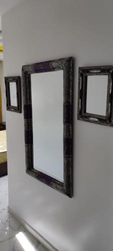 two framed pictures on a white wall at Superbe appart 3pieces a sania plage MARINA SMIR in M'diq