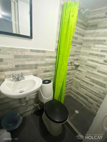 a bathroom with a sink and a toilet at Hospedaje Holcay in Bogotá