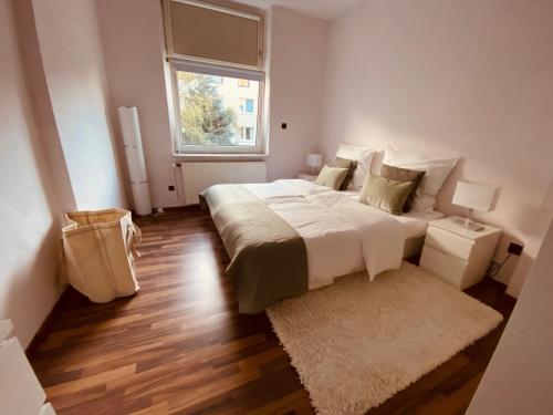 a bedroom with a large bed and a window at Tolle Stadtwohnung mit guter Verkehrsanbindung Von der Goltz 35 in Dortmund