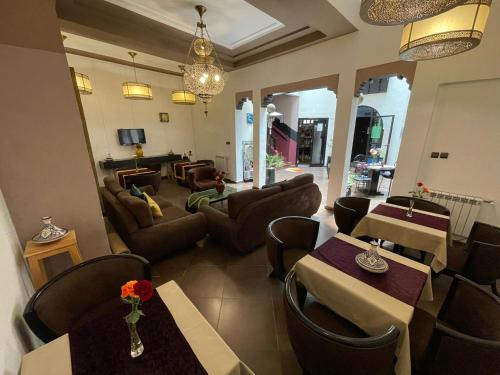 a living room with couches and tables and chairs at Riad 7 Pierres in Essaouira