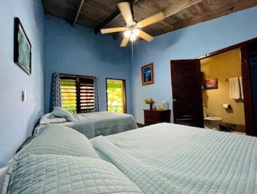 a bedroom with two beds and a ceiling fan at Reef House Resort in Oak Ridge