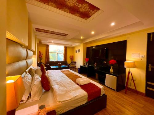 a bedroom with a large bed in a room at Reo Resort, near bus stand & railway station ,Haridwar in Haridwār