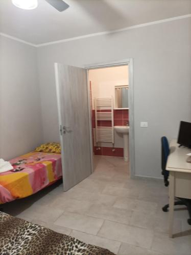 a bedroom with a bed and a desk and a deskablish at Valery AffittaCamere in Capannori