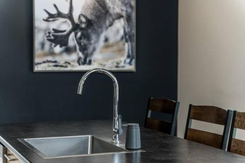 a kitchen sink with a deer picture on the wall at Initial - Soeur No19 - MSA in Saint-Férréol-les-Neiges