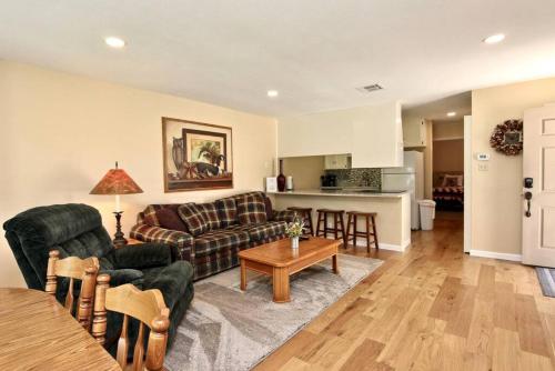 a living room with a couch and a table at Comal River Bliss in New Braunfels
