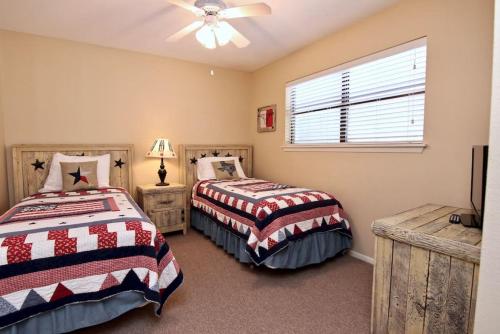 a bedroom with two beds and a window at Comal River Bliss in New Braunfels