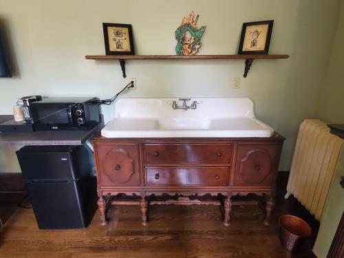 a bathroom with a sink and a microwave at Daniell Manor in Laurium