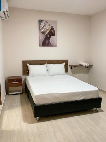 a bedroom with a large bed with a white bedspread at Hotel Andina Blue Santa Marta in Santa Marta