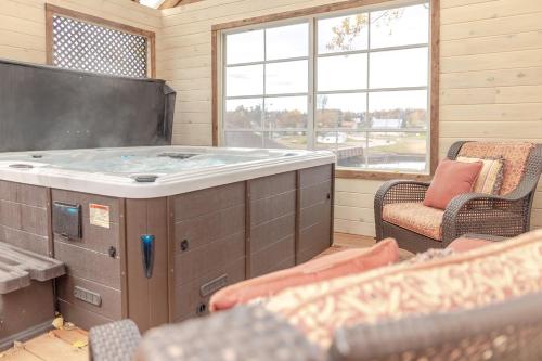 a hot tub in a room with chairs and a tv at The Olde Anchor Bed & Breakfast in Murray River
