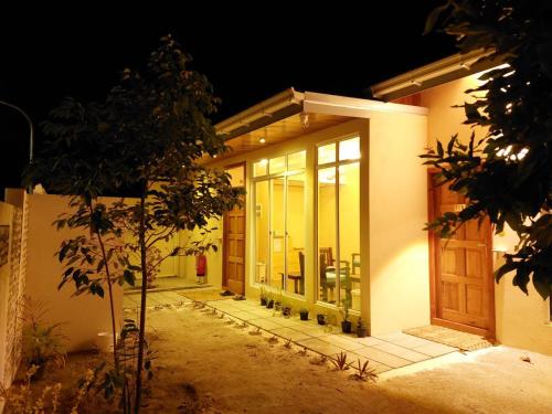 a front door of a house at night at AYIRA Maldives in Feridhoo