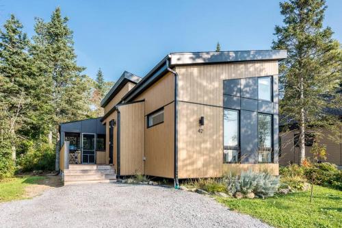 a house with a large glass door on a driveway at Initial / Mano / MSA in Saint-Férréol-les-Neiges