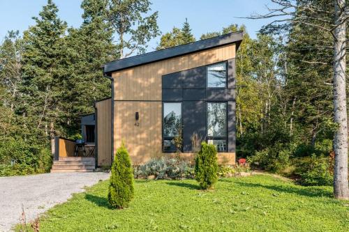 a small house with a black roof at Initial / Mano / MSA in Saint-Férréol-les-Neiges