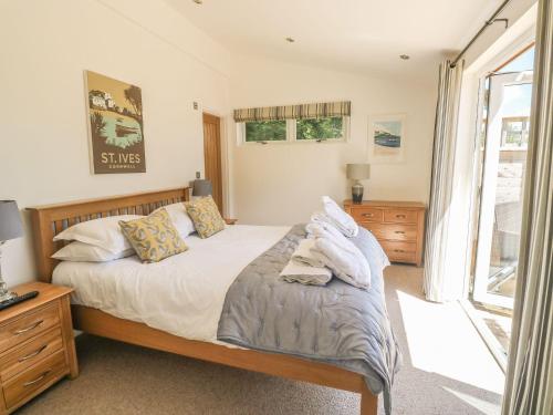 a bedroom with a bed and a window at 15 Horizon View in Liskeard