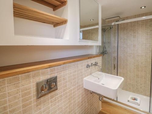 a bathroom with a sink and a mirror at 15 Horizon View in Liskeard