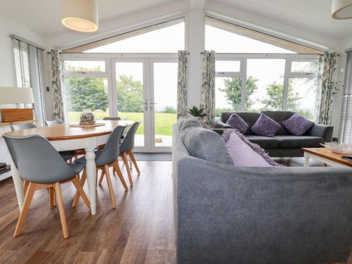 a living room with a couch and a table at 9 Horizon View in Liskeard