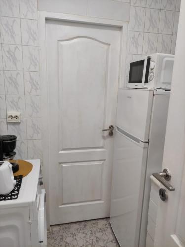 a white door in a kitchen with a microwave at Royal Studio in Old Town in Bucharest