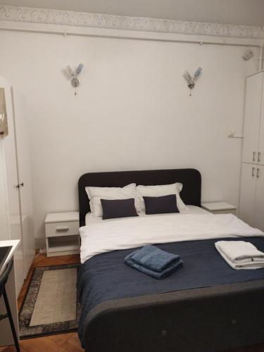 a bedroom with a large bed with two butterflies on the wall at Royal Studio in Old Town in Bucharest