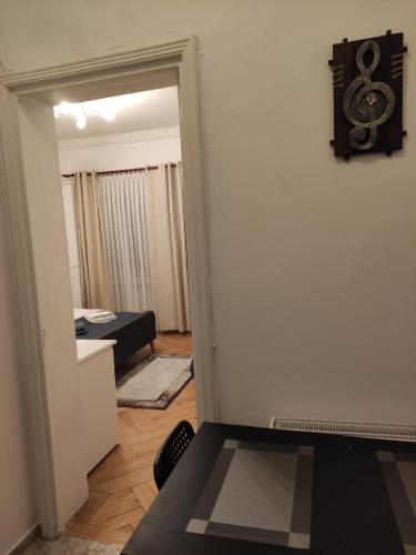 a room with a door leading to a room with a bed at Royal Studio in Old Town in Bucharest
