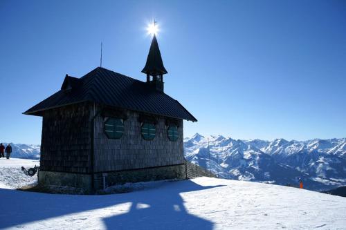 a small building on top of a snow covered mountain at Apartments Lakeside 29 Zell am See in Zell am See