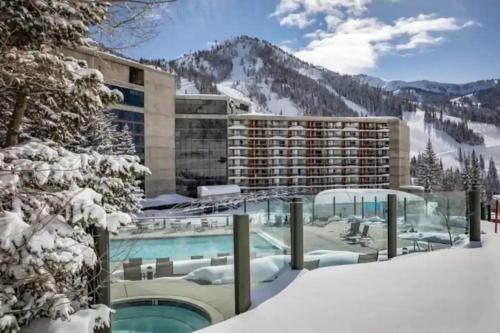 a resort with a swimming pool in the snow at Ski-In Ski-Out - The Cliff @ Snowbird in Sandy