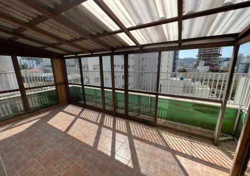 an empty balcony with a view of a city at Pousada Louise in Balneário Camboriú