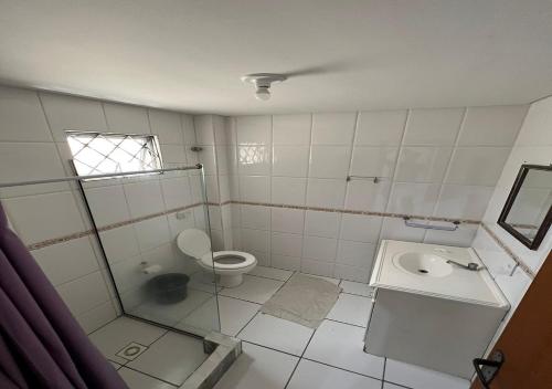 a bathroom with a toilet and a sink at Residencial Louise in Balneário Camboriú