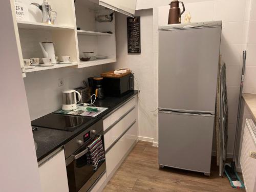 a small kitchen with a refrigerator and a stove at Munich Aparthotel in Munich