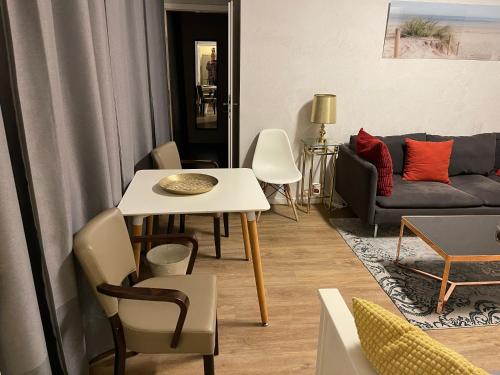 a living room with a table and a couch at Munich Aparthotel in Munich