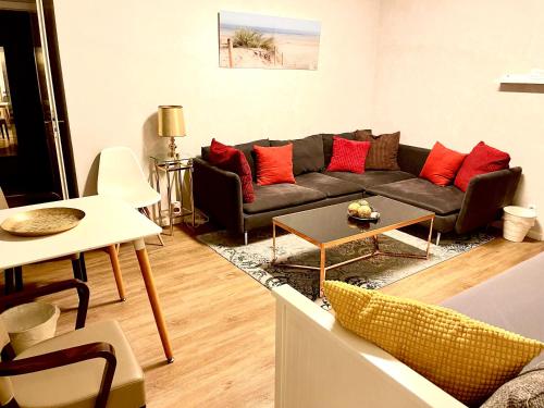 a living room with a couch and a table at Munich Aparthotel in Munich