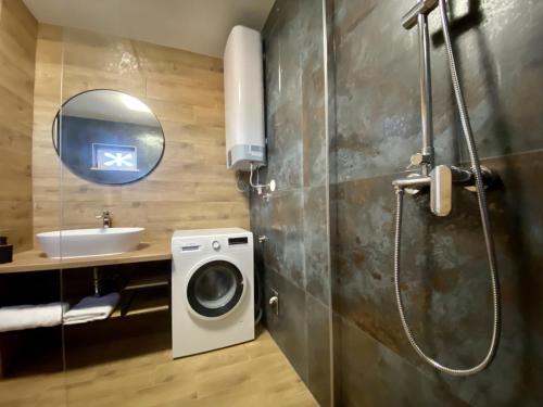 a bathroom with a washing machine and a sink at Villa FJERA - sea view, hot tubs, terrace, BBQ in Pučišća