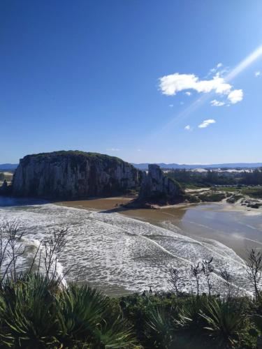 a view of a beach with a cliff at Bella Ciao Hospedaria in Passo de Torres