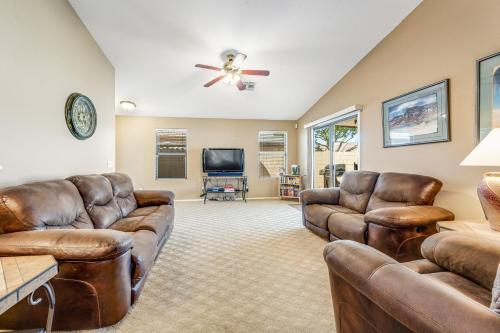 a living room with leather furniture and a flat screen tv at Good Times in Goodyear in Goodyear