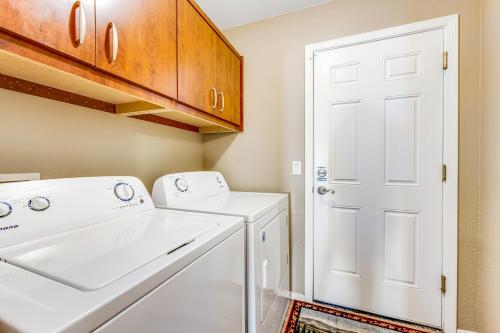 a laundry room with a white washer and dryer at Good Times in Goodyear in Goodyear