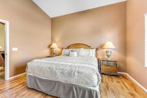 a bedroom with a large bed and two lamps at Good Times in Goodyear in Goodyear