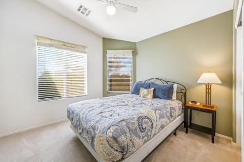 a bedroom with a bed and a table with a lamp at Good Times in Goodyear in Goodyear