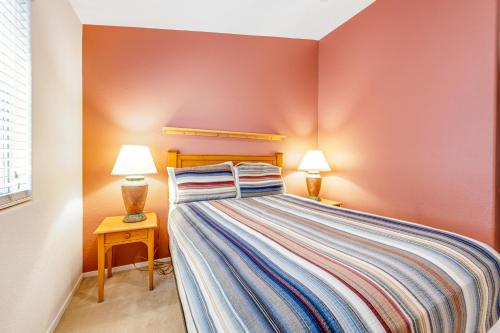 a small bedroom with a bed and two lamps at Good Times in Goodyear in Goodyear