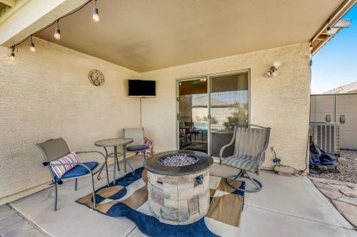a patio with chairs and a table and a tv at Good Times in Goodyear in Goodyear
