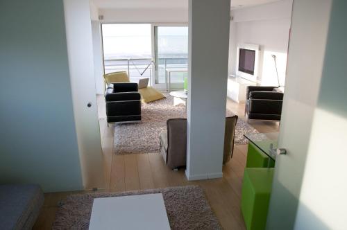 a living room with a view of the ocean at The Lighthouse in Koksijde