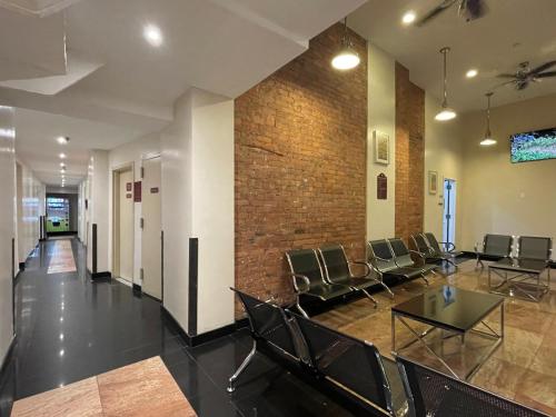 a room with chairs and a brick wall at Hotel and the City, Rooftop City View in New York