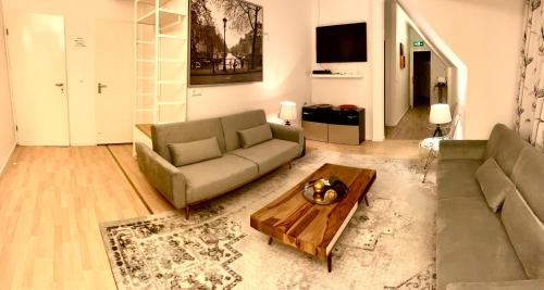 a living room with a couch and a coffee table at Munich Aparthotel in Munich