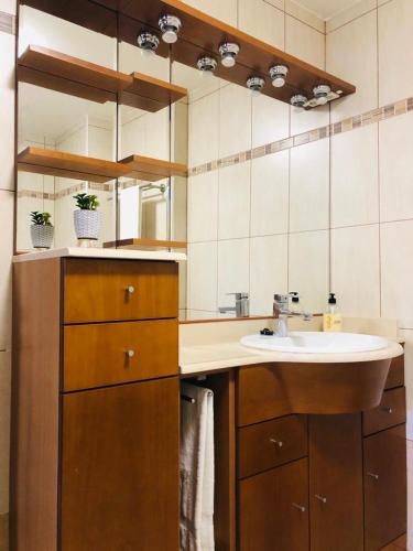 a bathroom with a sink and a mirror at Solen Suites Arguineguin in Arguineguín