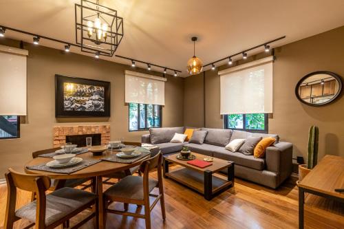 a living room with a couch and a table at Nido Roma Norte in Mexico City