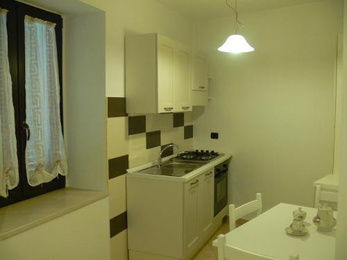 a small kitchen with a sink and a stove at Residenza Sulla Roccia in Bovino