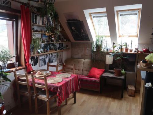 a living room with a table and a couch at Byt 4+kk v klidné části obce Bedřichov in Bedřichov