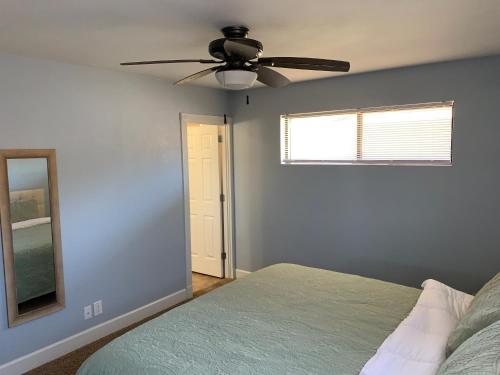 a bedroom with a ceiling fan and a bed at Sapphire Lake House* Boat Parking for 2 + Backyard in Page