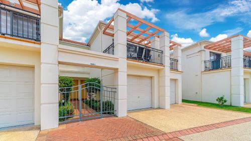 a large white house with two garages at Breakers Block 5 Unit 6 in Yamba