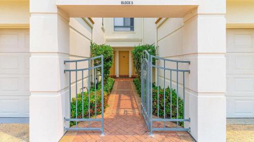 a house with a gate in front of a building at Breakers Block 5 Unit 6 in Yamba