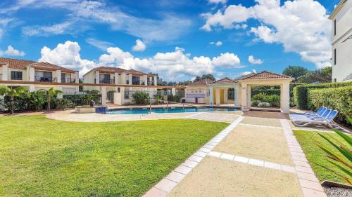 a mansion with a swimming pool and a yard at Breakers Block 5 Unit 6 in Yamba