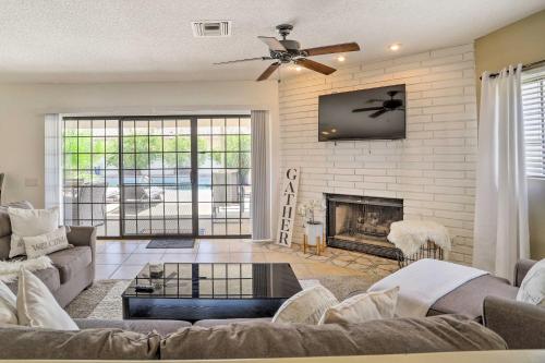a living room with a couch and a fireplace at Bright Indio Home with Pool about 2 Mi to Coachella in Indio